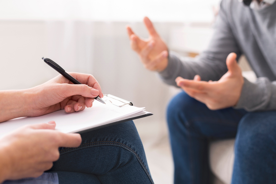 man smiling while discussing treatment