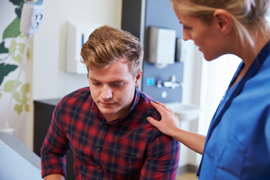 young man in a medical office receiving treatment