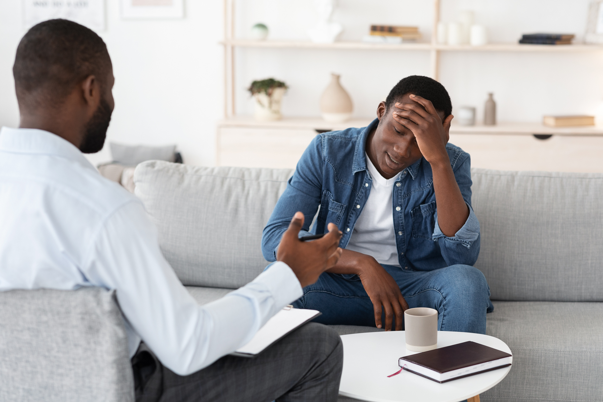 Man holding his forehead in frustration during DBT for addiction, ocd and addiction treatment, ocd, obsessive compulsive disorder,