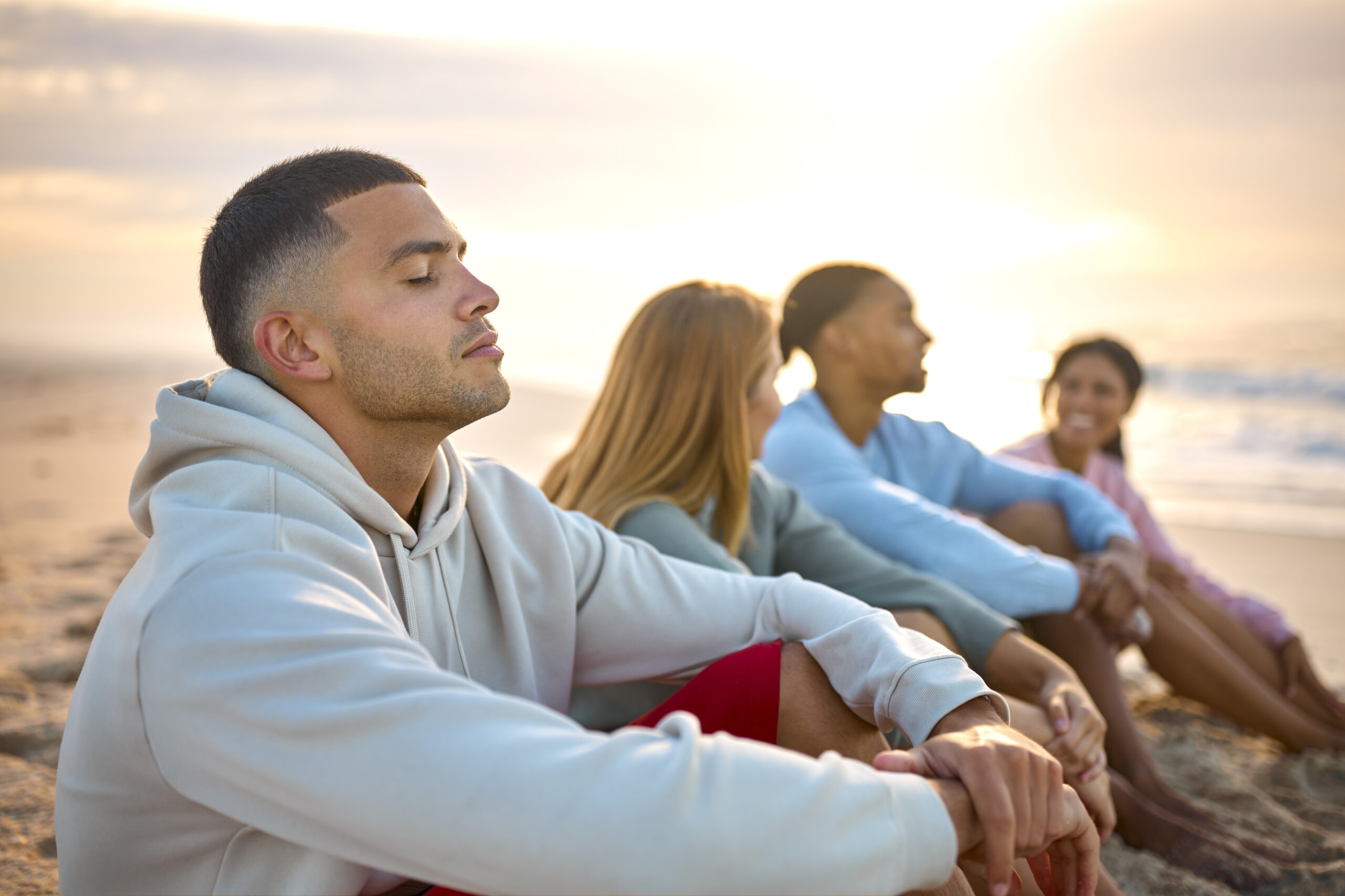 Man With Closed Eyes Relaxing With Friends On Vacation Sitting On Beach Watching Sunrise Together vicodin addiction treatment, vicodin addiction, vicodin addiction treatment in san diego, what is vicodin, symptoms of vicodin addiction